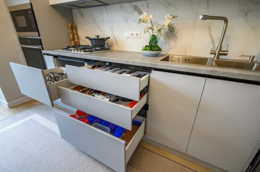 A kitchen with drawers and a sink.